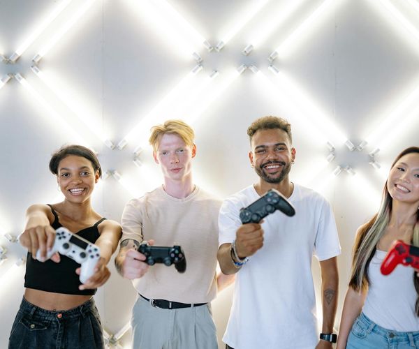 A diverse group of people of different ages smiling in a bright yoga studio.